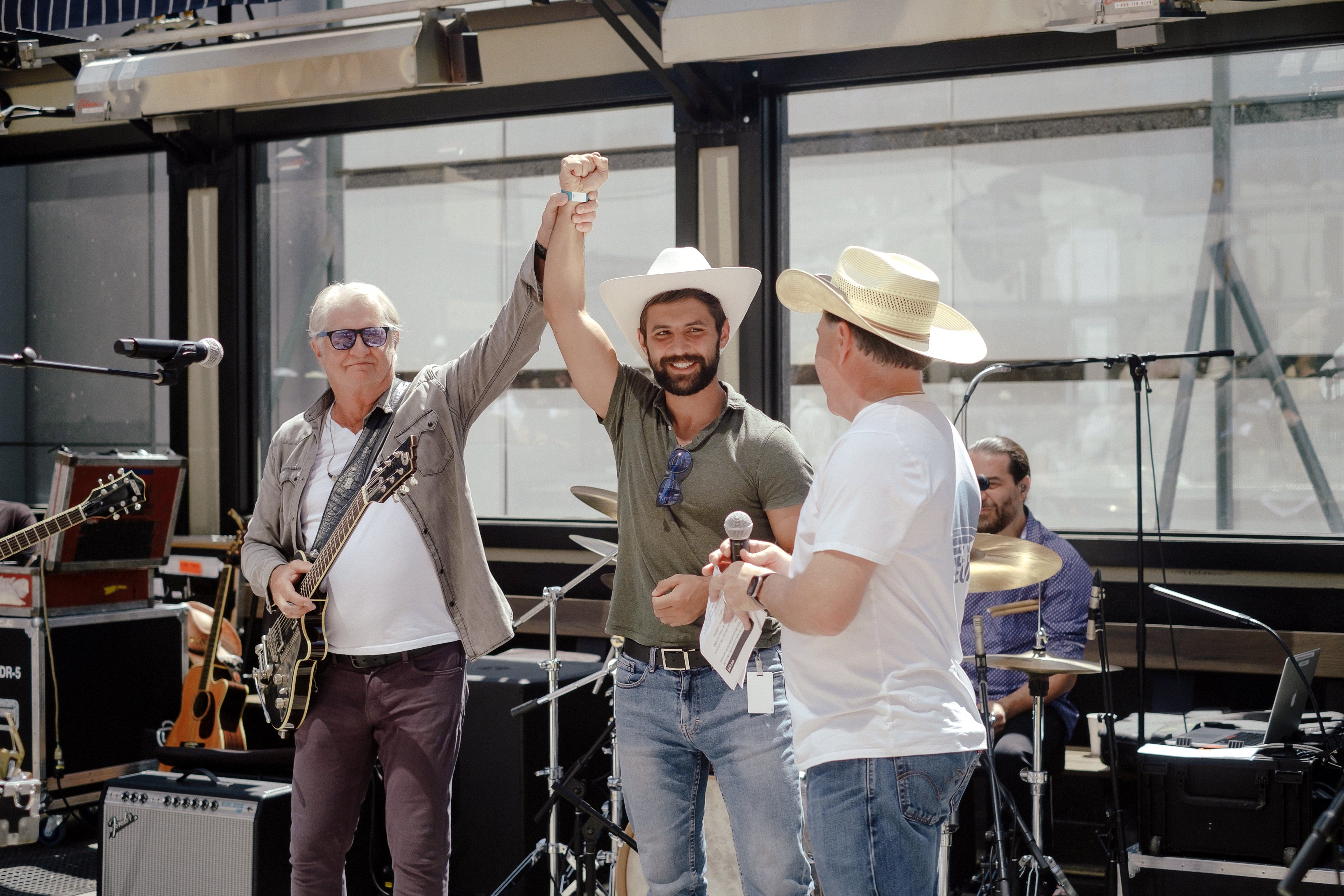 Tom Cochrane, Yuri Mykhailenko and Rene Amirault after Yuri received his white hat